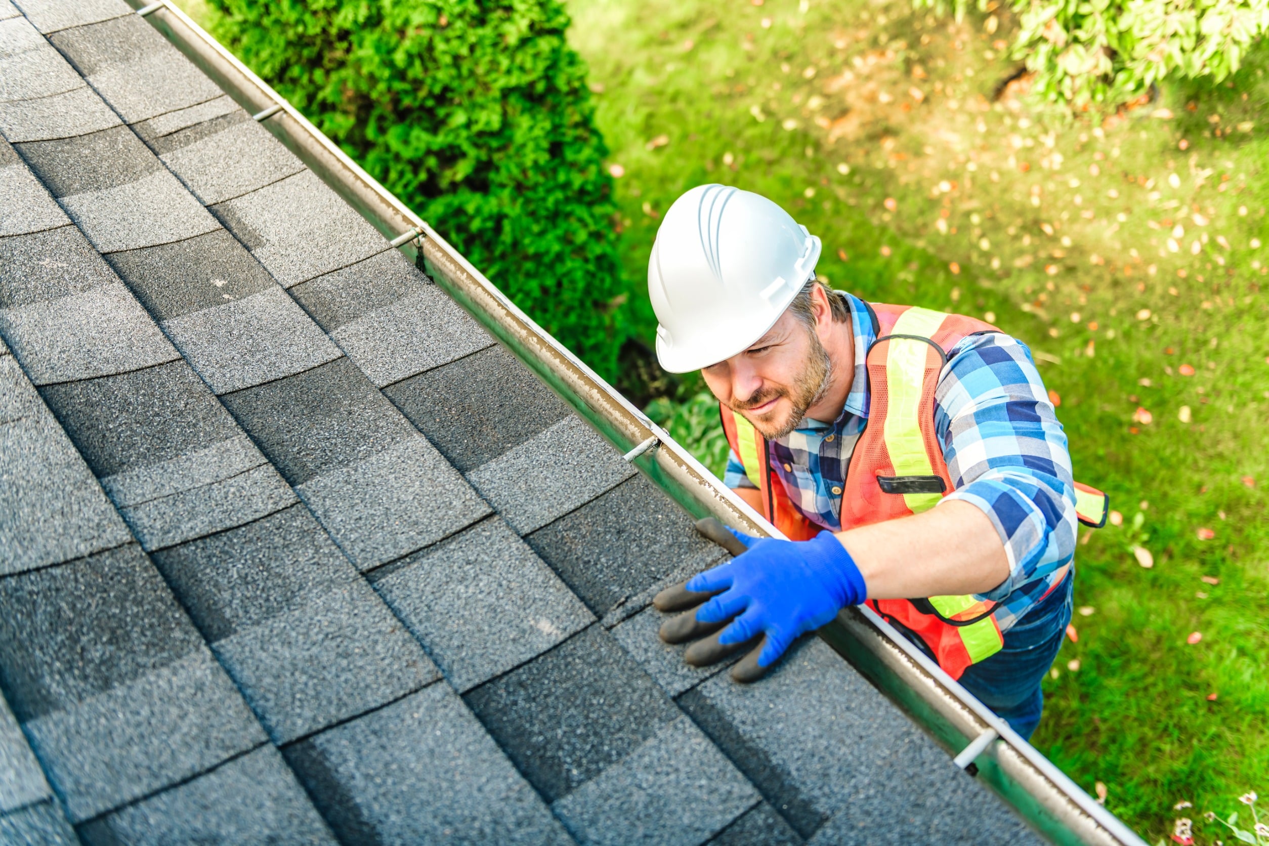 a man wearing a hard hat and gloves on roof new customer special