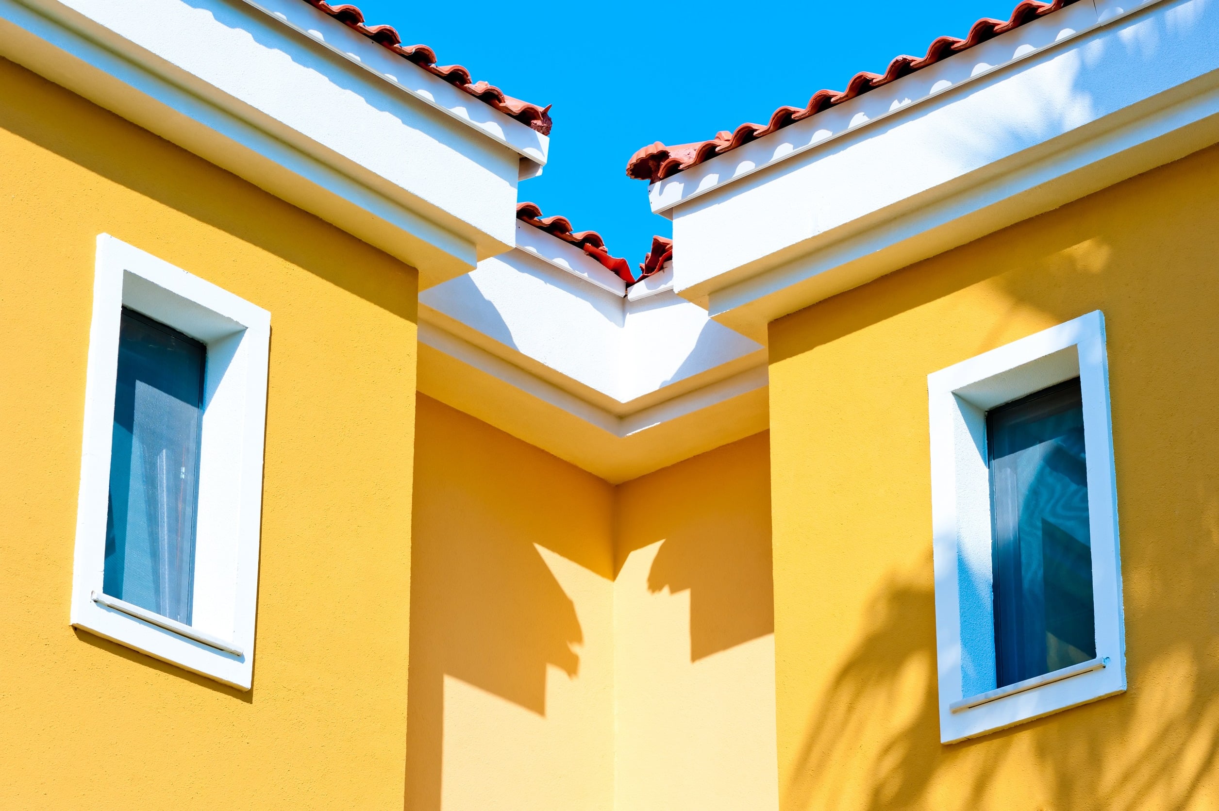 a yellow building with white trim