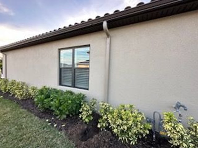 a house with a gutter and plants